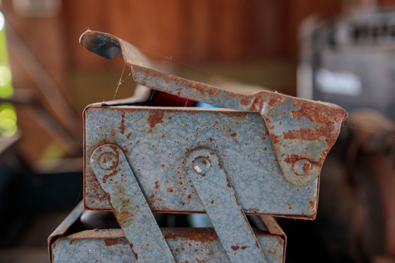 Manuals Storage - a rusted metal object sitting on top of a table