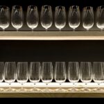 Beverage Cooler - clear drinking glasses on blue wooden shelf