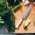 Fresh Herbs - sliced cucumber and green vegetable on brown wooden chopping board