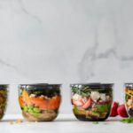 Food Containers - four clear plastic bowls with vegetables