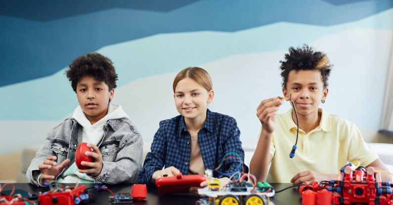 Electronic Toys - Kids Sitting Near a Table with Battery Operated Toys