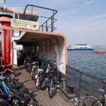 Bicycle Storage - black motorcycle parked beside red and white concrete building during daytime