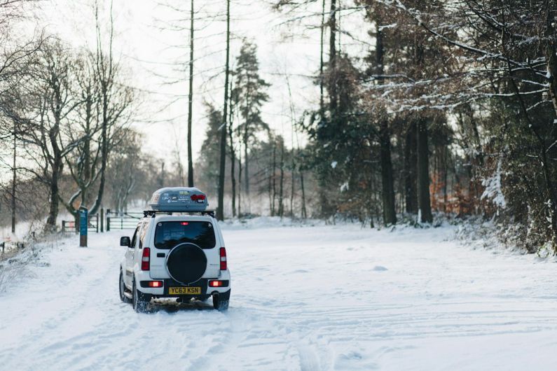 Seasonal Vehicles - white compact van at snow path