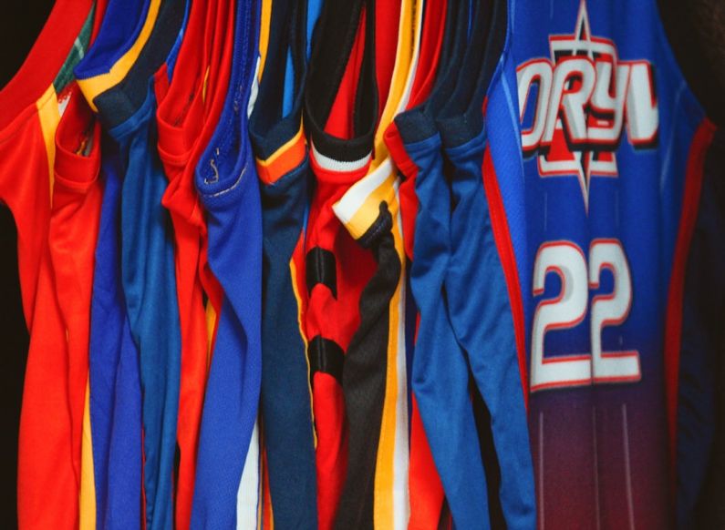 Sports Jerseys - a group of blue and red sports jerseys