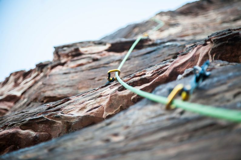 Climbing Gear - selective focus photo of green climbing safety rope