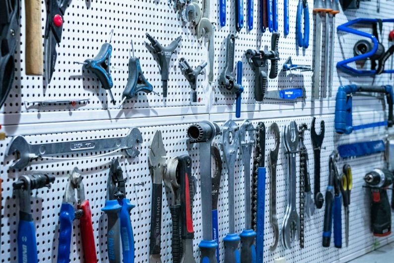Bicycle Tools - a bunch of tools hanging on a wall