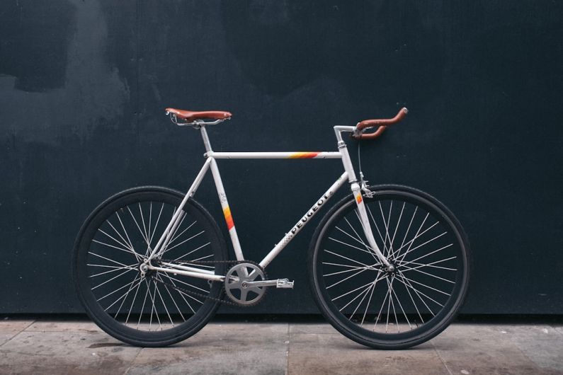 Vertical Bike Rack - gray fixie bike leaning on black wall